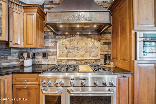 kitchen with stainless steel appliances, brown cabinets, decorative backsplash, and custom range hood