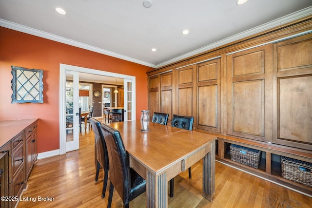 dining space featuring french doors, crown molding, recessed lighting, light wood-type flooring, and baseboards