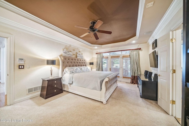 carpeted bedroom featuring visible vents, a ceiling fan, access to outside, a tray ceiling, and crown molding