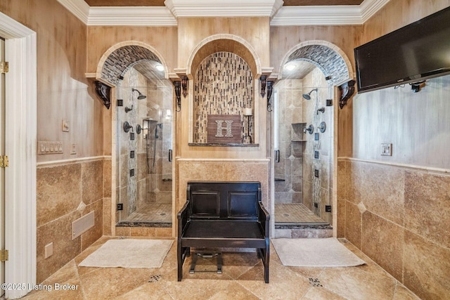 bathroom featuring a stall shower, tile walls, and crown molding