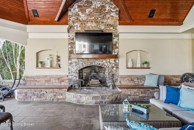 living room featuring lofted ceiling, wood ceiling, and an outdoor stone fireplace