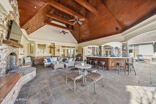 view of patio featuring an outdoor living space with a fireplace, outdoor dry bar, and ceiling fan