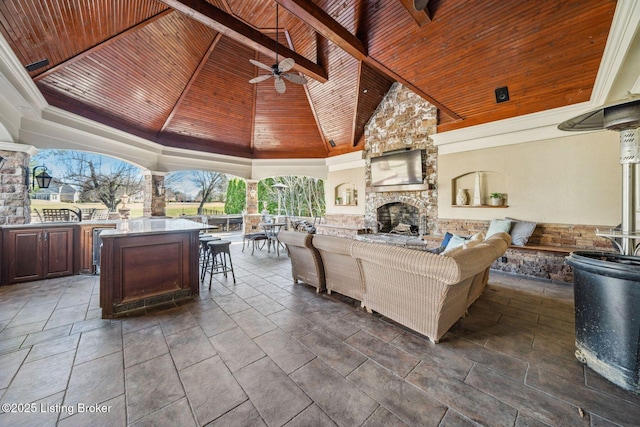 interior space featuring a gazebo, outdoor dining area, an outdoor living space with a fireplace, and a ceiling fan