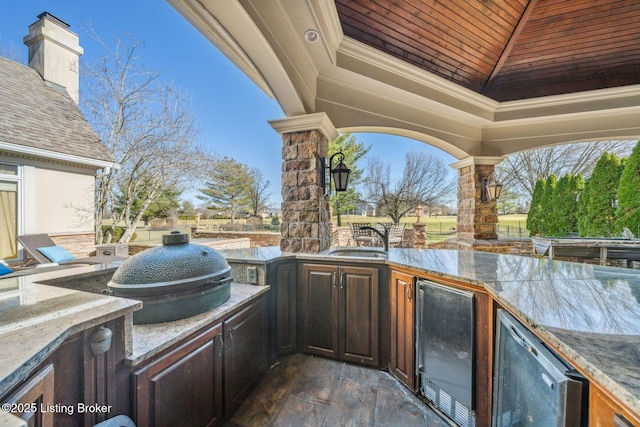 view of patio / terrace featuring a gazebo, wine cooler, an outdoor kitchen, and a sink