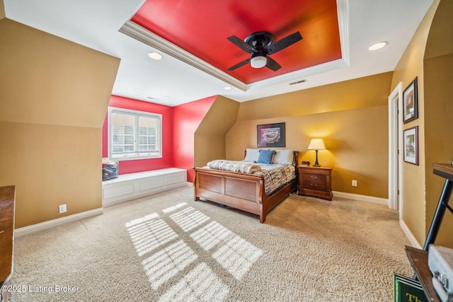 carpeted bedroom with a tray ceiling, crown molding, recessed lighting, visible vents, and baseboards