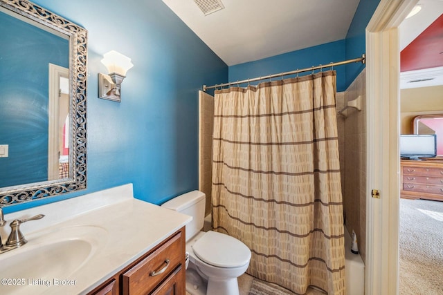 bathroom featuring curtained shower, visible vents, vanity, and toilet