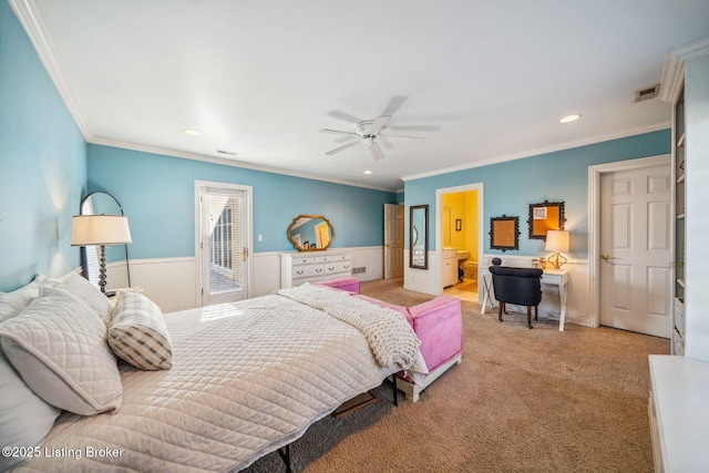 bedroom with ornamental molding, light colored carpet, wainscoting, and visible vents