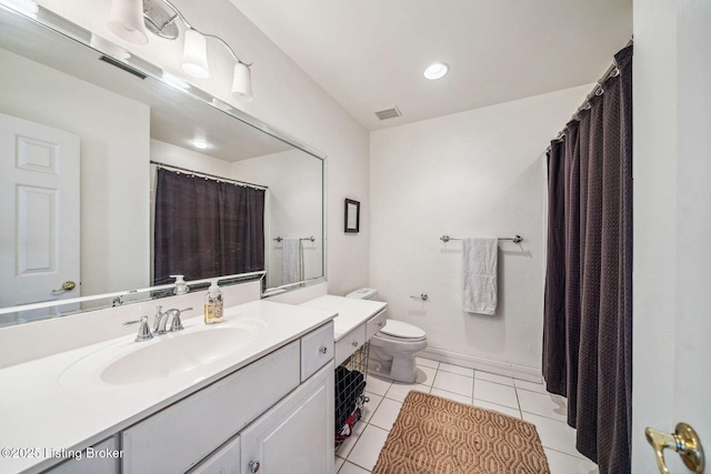 bathroom with visible vents, toilet, vanity, tile patterned flooring, and baseboards