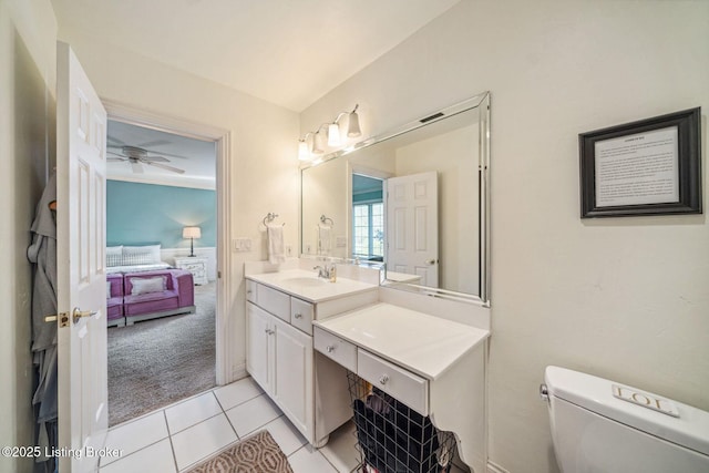 bathroom with toilet, ensuite bath, ceiling fan, tile patterned flooring, and vanity