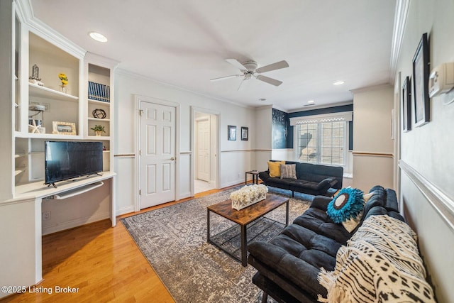 living area featuring recessed lighting, wood finished floors, a ceiling fan, and crown molding