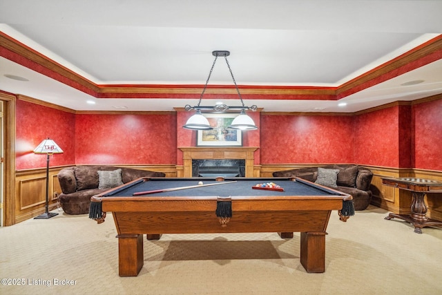 playroom with a tray ceiling, a wainscoted wall, and carpet flooring