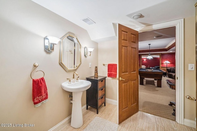 bathroom with pool table, visible vents, a sink, and baseboards