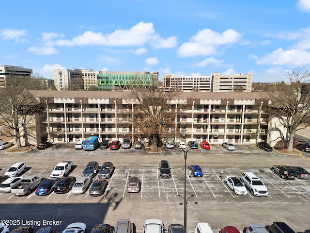 view of property featuring uncovered parking and a city view