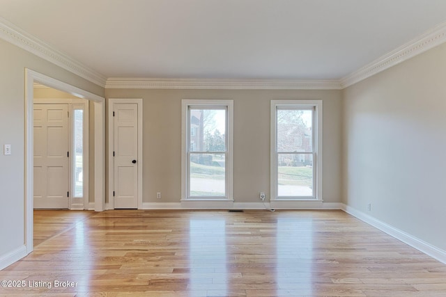 entrance foyer with light wood finished floors, baseboards, and ornamental molding