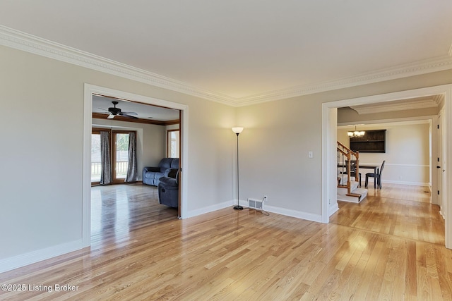 unfurnished room featuring a notable chandelier, visible vents, baseboards, ornamental molding, and light wood finished floors