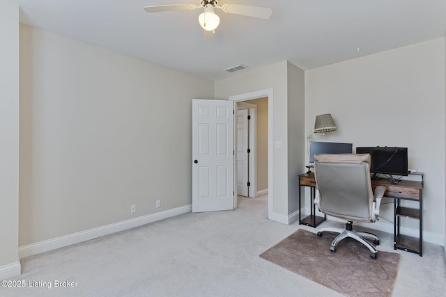 carpeted office space featuring visible vents, ceiling fan, and baseboards