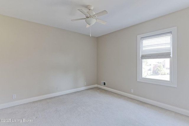 unfurnished room featuring baseboards, carpet floors, visible vents, and a ceiling fan