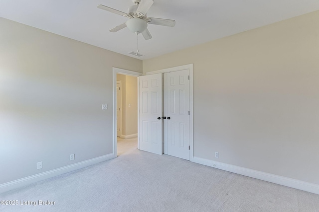 interior space with carpet floors, baseboards, visible vents, and ceiling fan