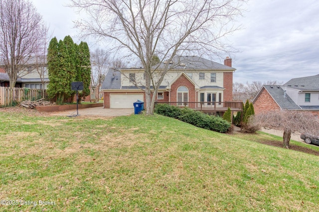 view of front facade with a garage, brick siding, fence, a chimney, and a front yard