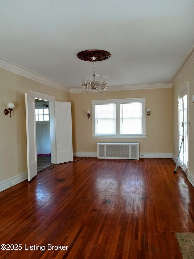 unfurnished room with a notable chandelier, ornamental molding, dark wood-style flooring, and radiator