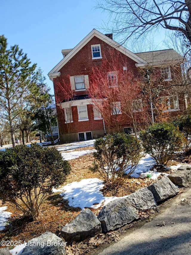 view of side of home featuring brick siding