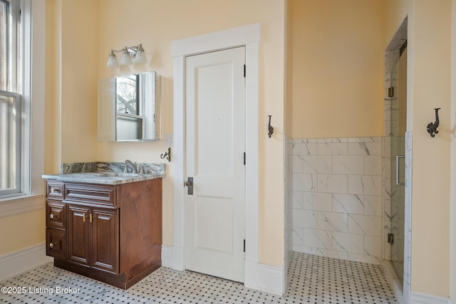 bathroom featuring a shower stall and vanity