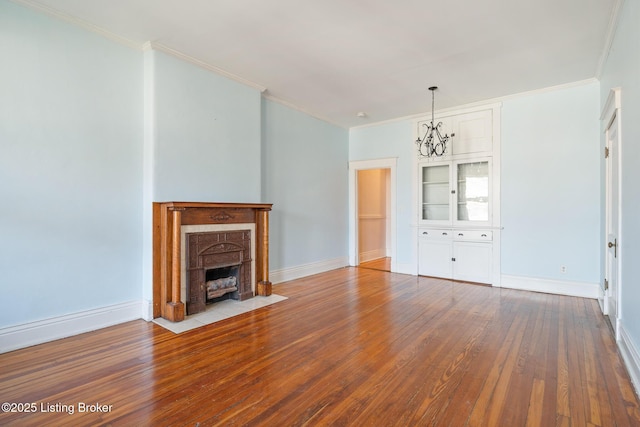 unfurnished living room featuring baseboards, a fireplace with flush hearth, ornamental molding, and hardwood / wood-style floors