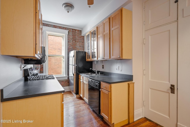 kitchen with light wood-style floors, glass insert cabinets, dishwasher, and a sink