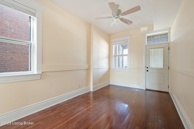 entrance foyer with wood-type flooring, a ceiling fan, and baseboards