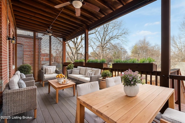 wooden deck with outdoor dining space, an outdoor living space, and a ceiling fan