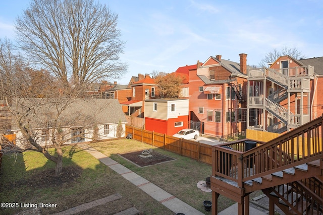 view of yard with fence and stairway