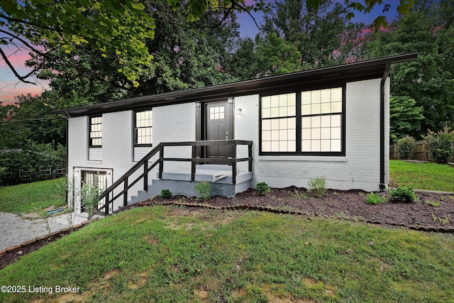 view of front of property with brick siding and a front yard