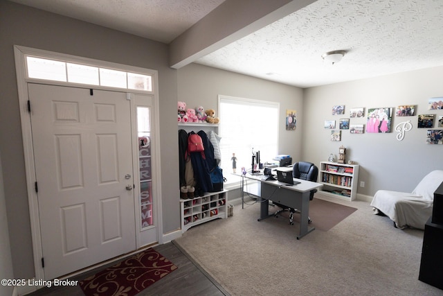 office with baseboards, a textured ceiling, and wood finished floors