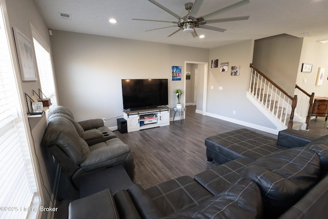 living area featuring recessed lighting, visible vents, wood finished floors, baseboards, and stairs