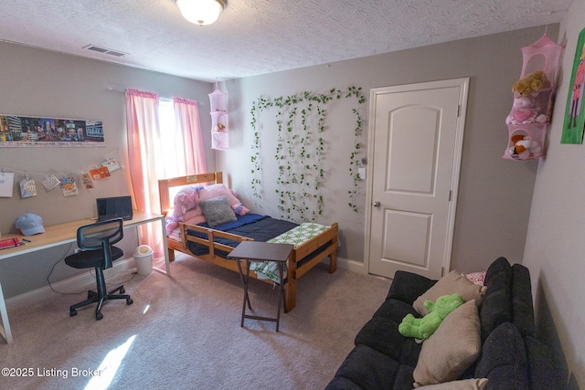 bedroom with carpet floors, baseboards, visible vents, and a textured ceiling