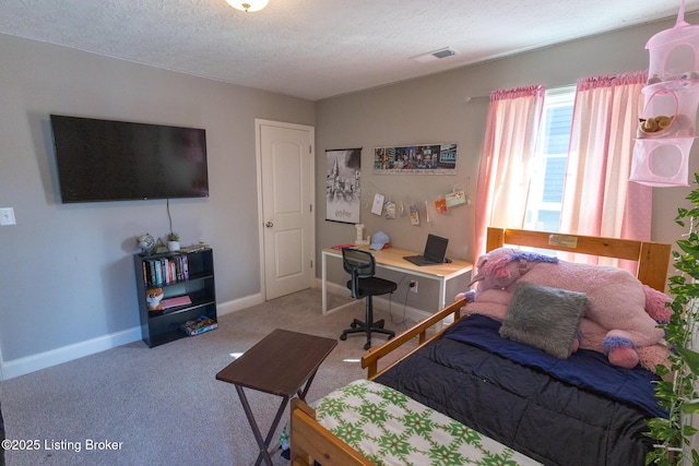 carpeted bedroom featuring visible vents, a textured ceiling, and baseboards