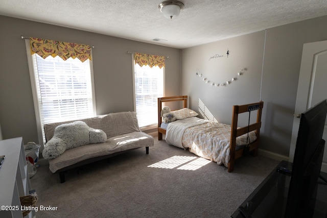 carpeted bedroom with visible vents and a textured ceiling