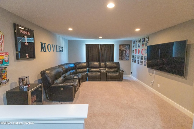 carpeted living area with recessed lighting and baseboards