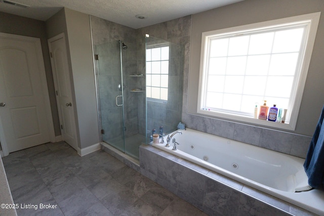 full bathroom with a stall shower, plenty of natural light, a tub with jets, and a textured ceiling