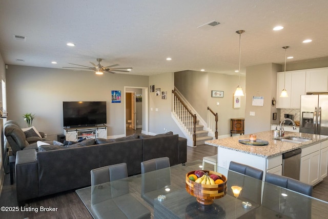 dining area with dark wood-style floors, stairway, visible vents, and recessed lighting