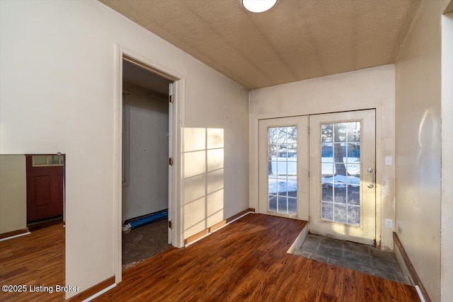 entryway featuring wood finished floors and baseboards