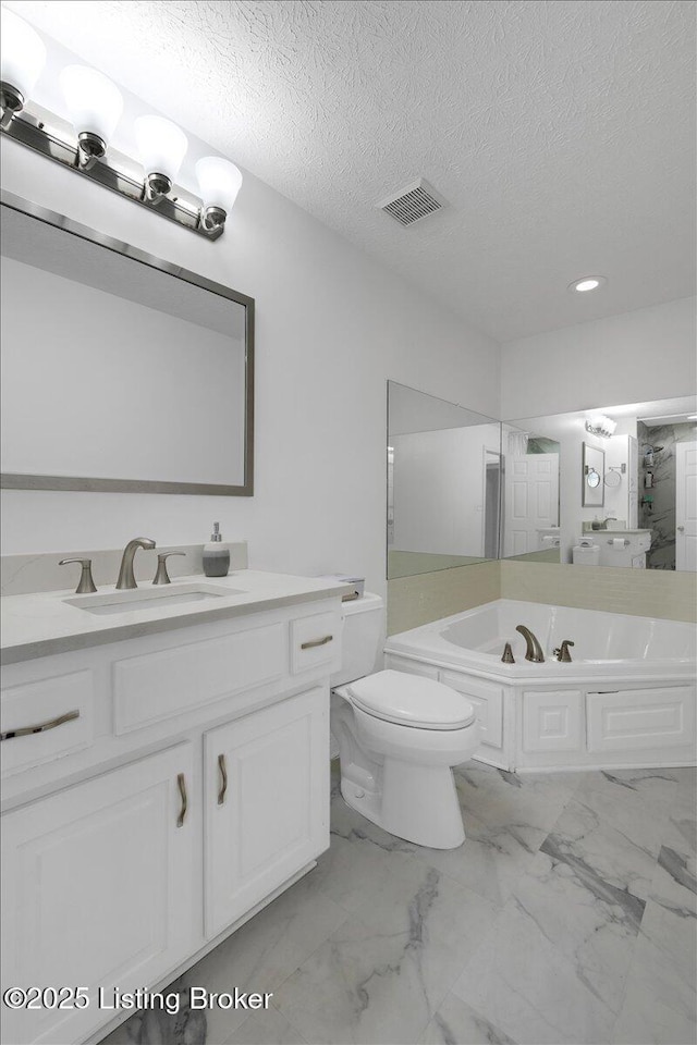 full bathroom featuring marble finish floor, visible vents, toilet, a textured ceiling, and a bath