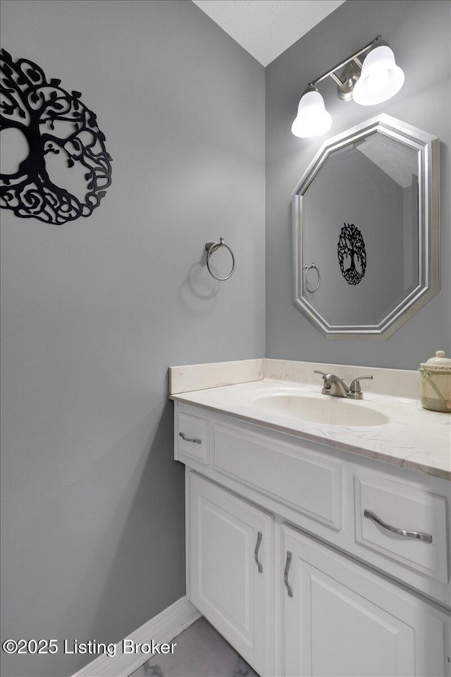 bathroom featuring baseboards and vanity