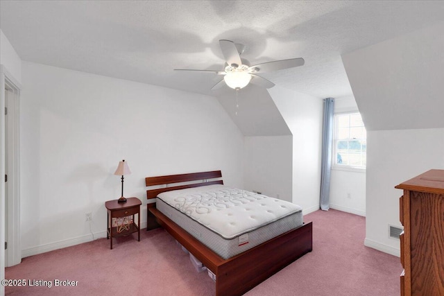 bedroom with vaulted ceiling, carpet floors, visible vents, and baseboards