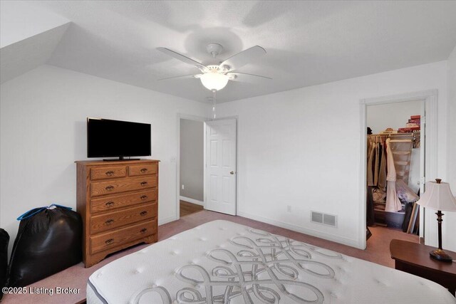 carpeted bedroom with baseboards, visible vents, a ceiling fan, a spacious closet, and a closet