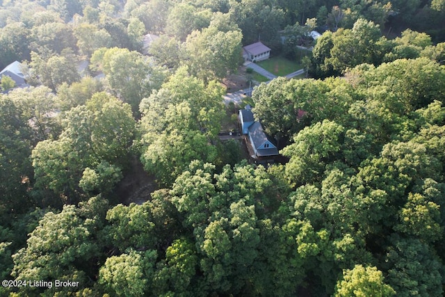 birds eye view of property featuring a view of trees