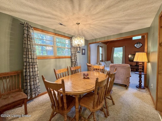 dining space featuring light carpet, visible vents, vaulted ceiling, a textured ceiling, and a notable chandelier