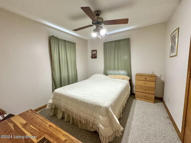 carpeted bedroom featuring a ceiling fan and baseboards