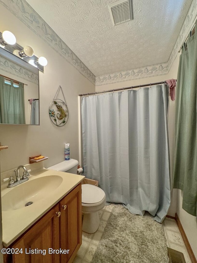 bathroom with toilet, a textured ceiling, vanity, and visible vents