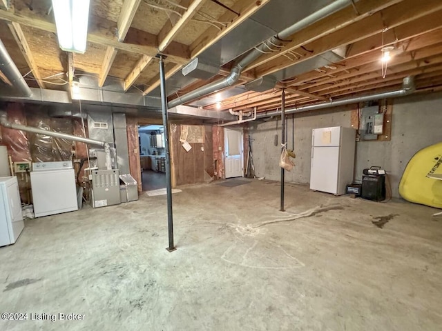 unfinished basement featuring freestanding refrigerator, electric panel, and independent washer and dryer